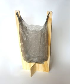 there is a plastic bag on the back of a wooden stand that is attached to a wall