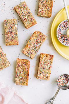 sprinkles on top of cake next to a yellow plate