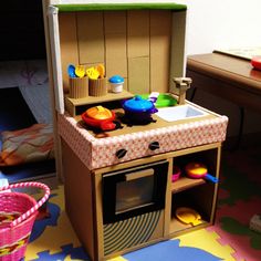 a play kitchen set is shown on the floor