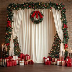 christmas decorations and presents are arranged in front of a curtain