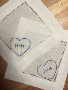 two pieces of cloth with embroidered hearts and the words mr and mrs written on them