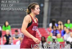 a woman in a red and black uniform is running with the words be a usa wrestler