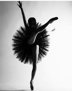 a black and white photo of a ballerina