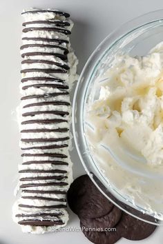 chocolate cookies and whipped cream in a glass bowl next to an ice cream sandwich roll