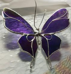 a purple butterfly sitting on top of a table