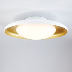 a white and gold ceiling light hanging from the ceiling