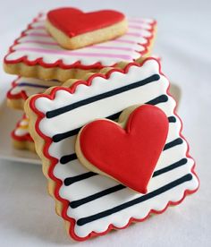 two heart shaped cookies sitting on top of each other