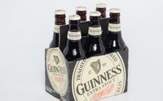 six bottles of guinness beer in a wooden box