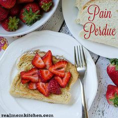 there is a piece of french toast with strawberries on it and the rest of the plate