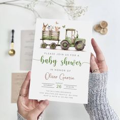 a person holding up a baby shower card