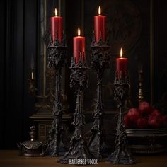 four red candles sitting on top of a wooden table