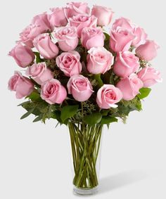 a vase filled with pink roses on top of a table