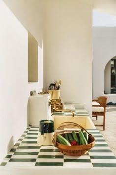 a bowl of vegetables sitting on top of a kitchen counter