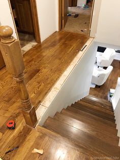 the stairs are being installed in an empty room with hard wood flooring and white walls