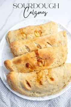 three pieces of bread on a plate with the words sourdough calzones