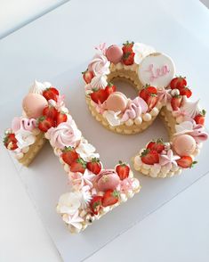 the letter e is made out of cookies and decorated with strawberries