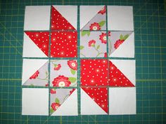 a quilted patchwork block with red and white flowers on it