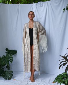 A kimono with a flower print made of a thin, soft satin fabric. It has ivory fringes on its sleeves, which make it both elegant and useful. Kimonos, Flower Print, A Flower, Satin Fabric, Flower Prints, Print Making, Make It, Kimono Top, Satin