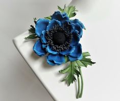 This delicate double anemone flower is part of Flower Breeze, the new collection of leather and floral hairpeices. Anemone is a totally new flower in our range and makes for a perfect summertime floral accessory. Striking round middle with black stamens around it immediately attracts glances. Made out of fine leather this anemone flower can be a groom's boutonnere or a compact brooch gift. This leather flower corsage is a perfect gift for the third wedding anniversary (the leather anniversary). Anemone Corsage, Third Wedding Anniversary, Raffia Hat, Leather Anniversary, Anemone Flower, Leather Flower, Flower Corsage, Floral Accessories, Leather Flowers