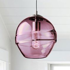 a pink light hanging from a ceiling in a room