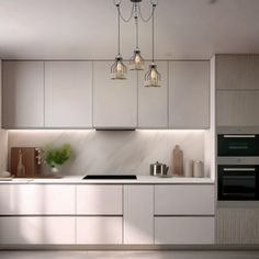 a modern kitchen with white cabinets and marble counter tops, lights hanging from the ceiling