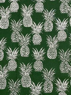 a green background with white pineapples on it