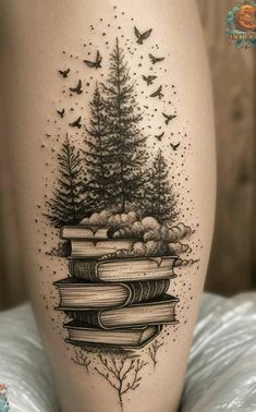 a woman's thigh with books and trees on it