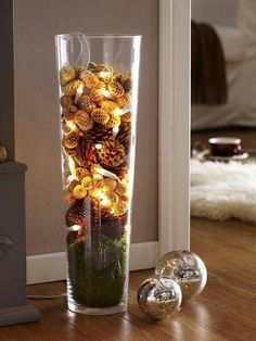 a vase filled with christmas decorations on top of a wooden floor