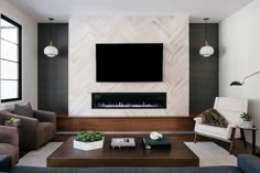 a living room with couches and a television mounted on the wall