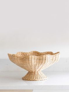 a wicker bowl sitting on top of a white counter