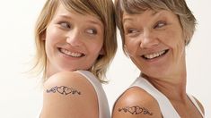 two women with matching tattoos on their arms