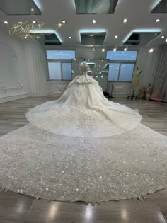 a wedding dress on display in a large room