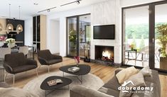 a living room filled with furniture and a flat screen tv mounted to the wall next to a fire place