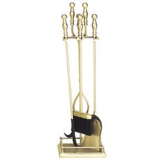 a gold metal rack with two brooms and a black mop on the bottom