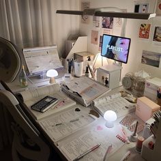 the desk is cluttered with papers, pens and other things to do on it