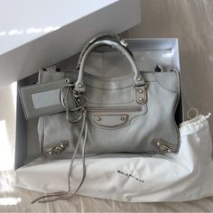 Balenciaga City Classic Metal Edge Satchel Bag Medium In Good Condition. Slight Wear On Bottom Corners And Bottom Metal Hardware. Leather. Comes With Mirror, Long Strap, And Box. Will Include Shopping Bag. Light Grey Color With Gold Hardware. Measurements: Handle Drop 4", Height 9", Width 15", Depth 5.5", Strap Drop 9-12" Mirror Long, Bags Balenciaga, Light Grey Color, Classic Metal, Balenciaga Bag, Bag Light, Satchel Bag, Medium Bags, Metal Hardware