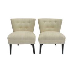 a pair of beige chairs sitting next to each other