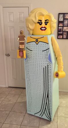 a lego man is standing in front of a door and holding a fire hydrant