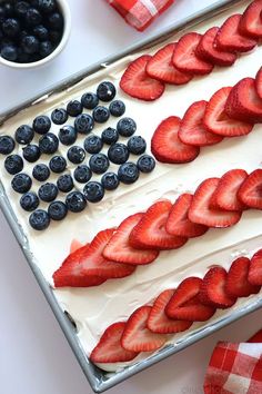 an american flag cake with strawberries and blueberries in the shape of the american flag