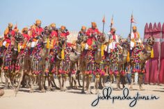 a group of men riding on the backs of camels