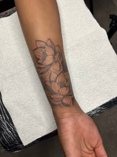 a person with a flower tattoo on their arm