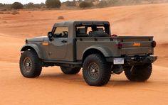 the truck is driving in the sand dunes