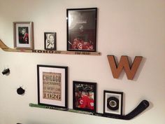 the wall is decorated with sports memorabilia and framed photographs, including hockey stickers and frames