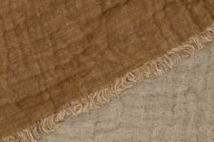 two different shades of brown and tan fabric with fringes on top of each other