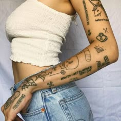 a woman with many tattoos on her arm and shoulder, holding onto a white background