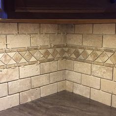 the corner of a kitchen counter with tile on it