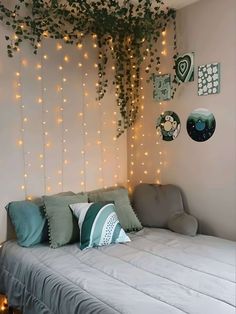 there is a bed with pillows and lights on the wall above it in this bedroom