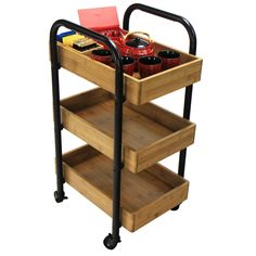 a wooden cart with three shelves on wheels and two trays holding various items in it