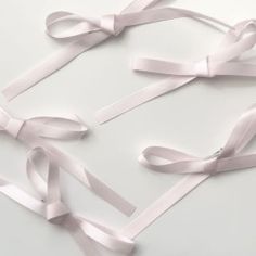 several white ribbons tied together on a table