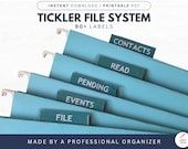 a stack of blue folders with the words tickler file system written on them